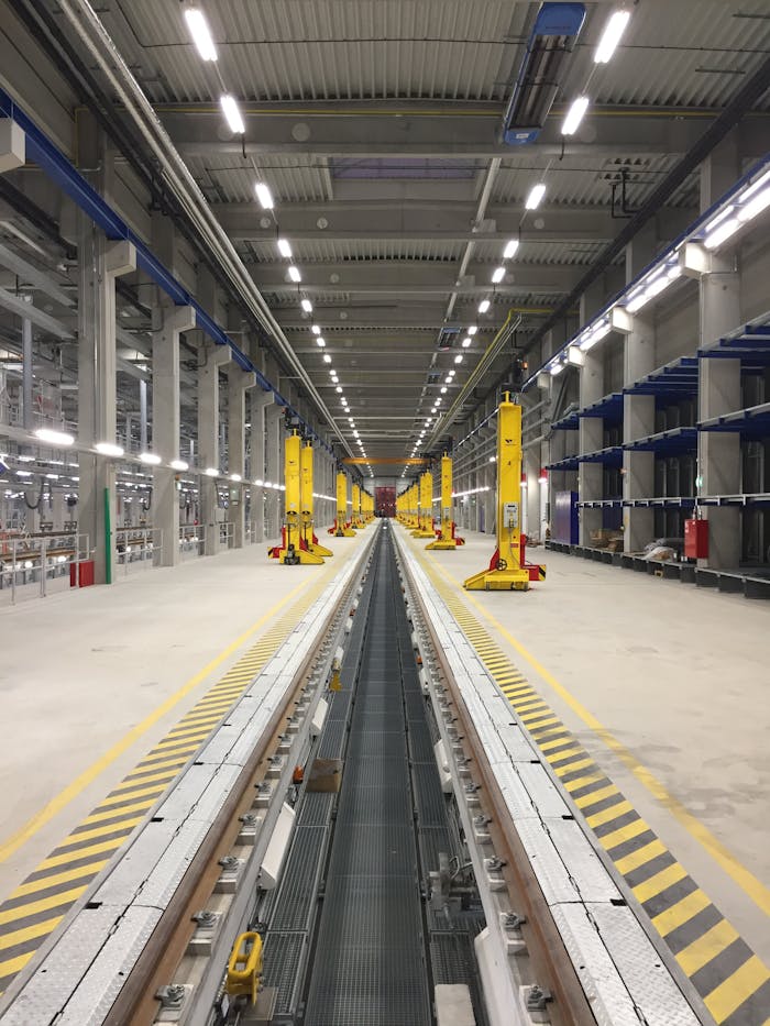 Services Spacious modern train maintenance facility with parallel tracks and industrial equipment.